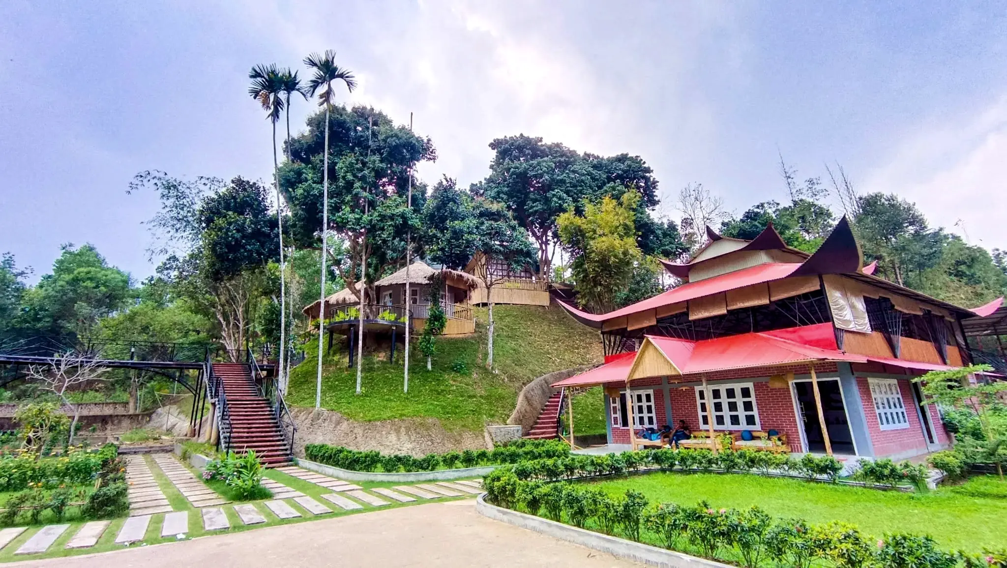 Phayre's Woods: hillside cottages and the red-roofed main building among tall trees